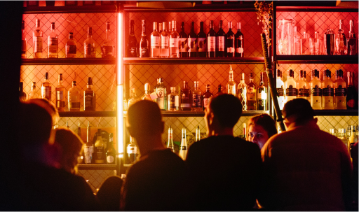 people sitting at a bar with bright lights